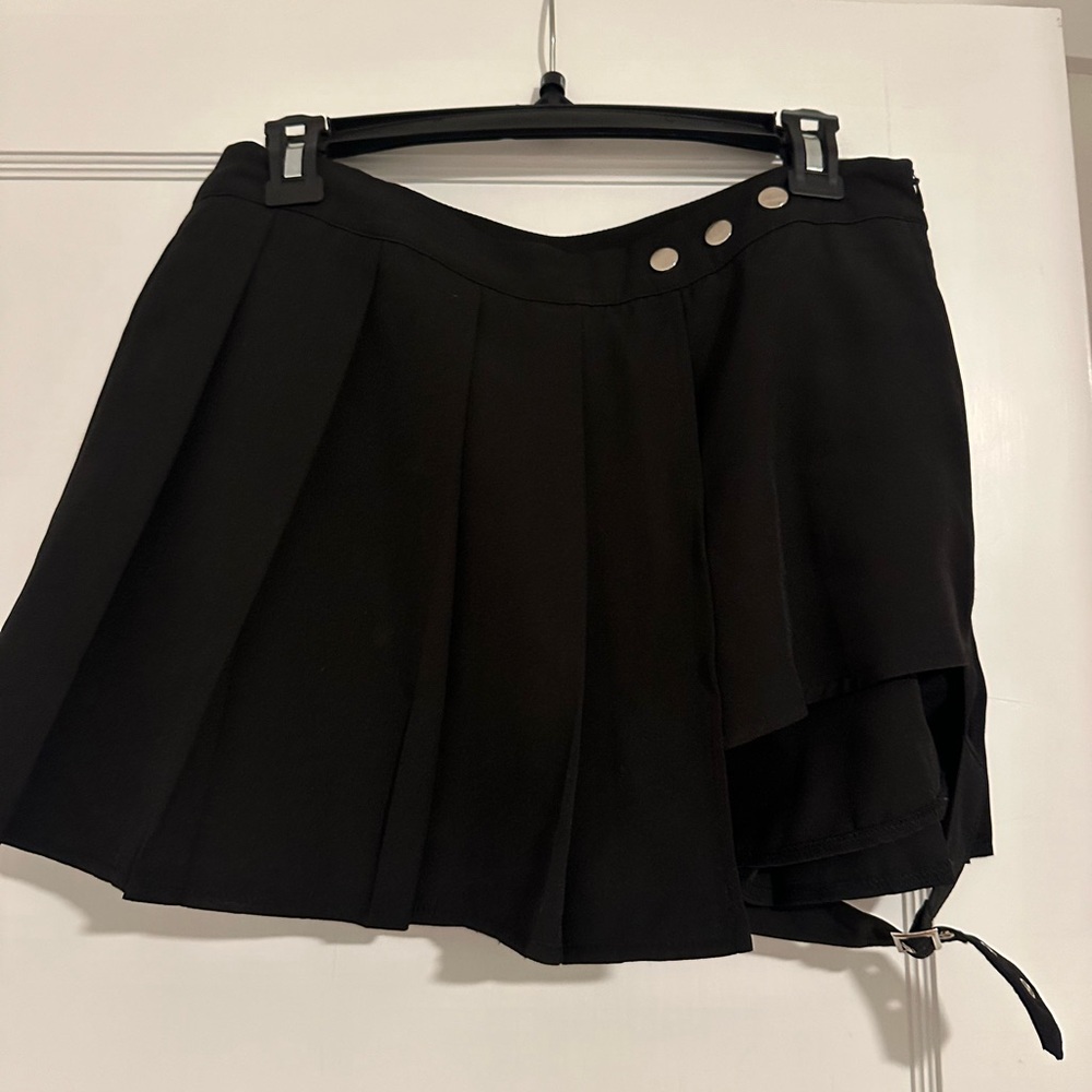 Pleated skirt with attached shorts and buckle